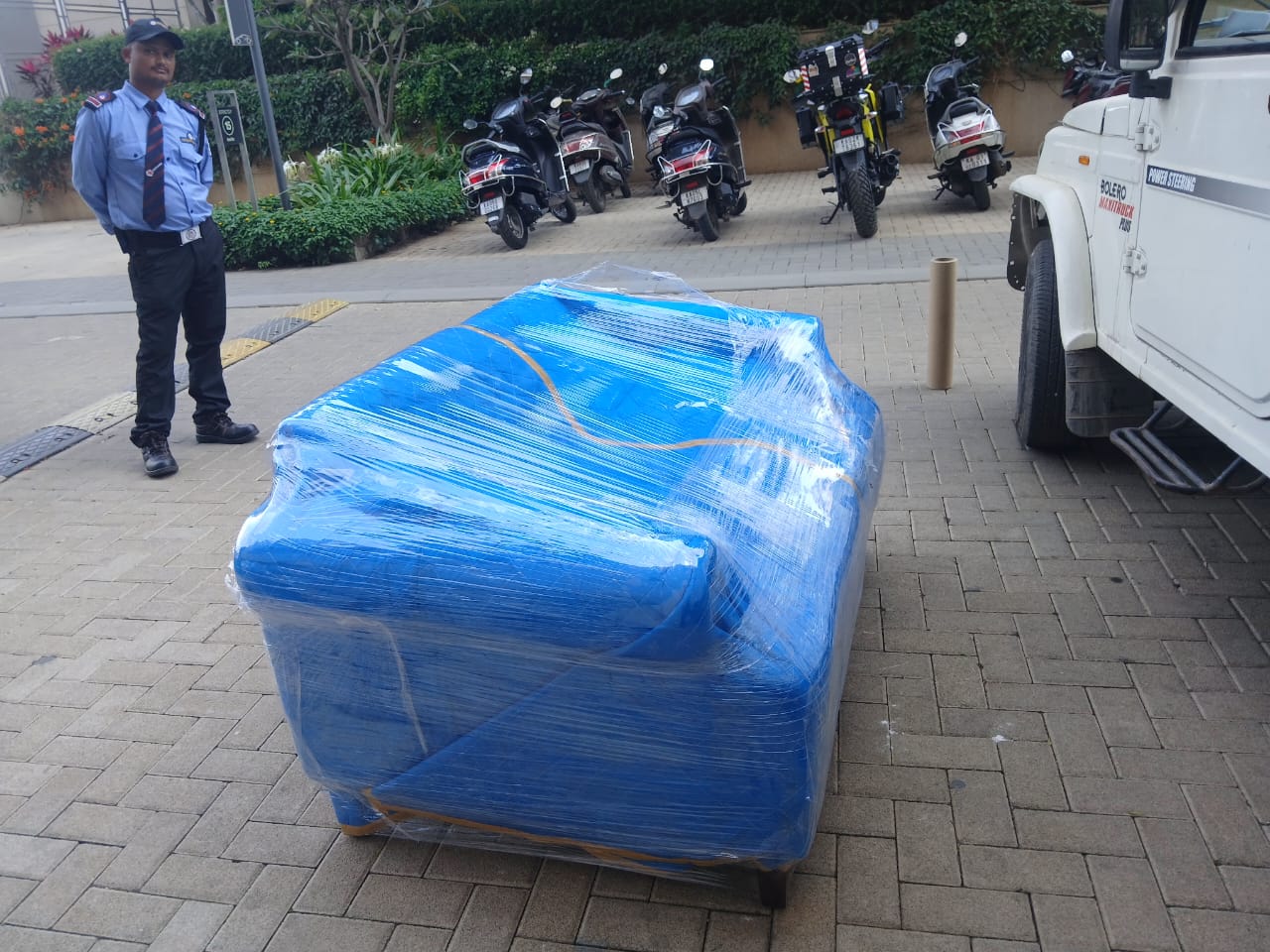 City house shifting wrapped sofa outside